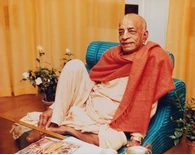 Srila Prabhupada Sitting Relaxed on Blue Seat Srila Prabhupada Sitting Relaxed on Blue Seat